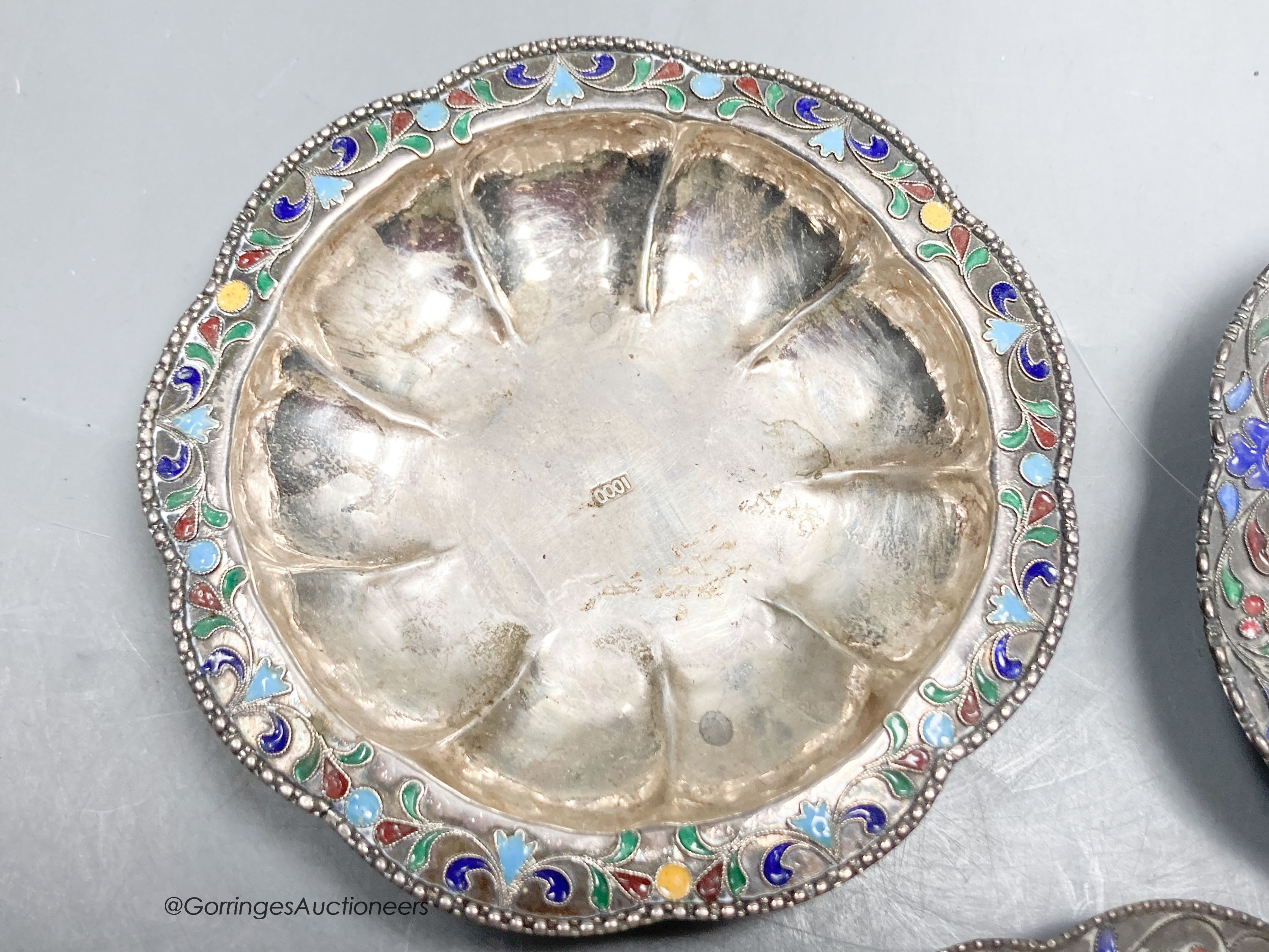 Three Persian white metal and cloisonne enamel small dishes, largest 9.6cm, gross weight 89 grams.
